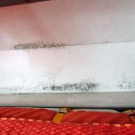 Under the cabinets; extreme rear