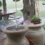Water splashing on top of rain barrel