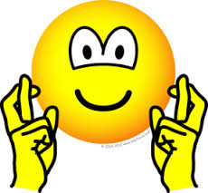 Smiley face with fingers crossed