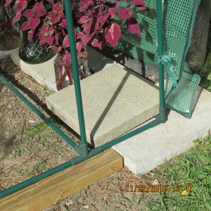 Cement block on east side of greenhouse